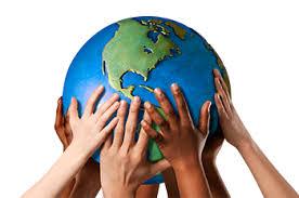 Photo of children's hands holding up a model of the Earth 